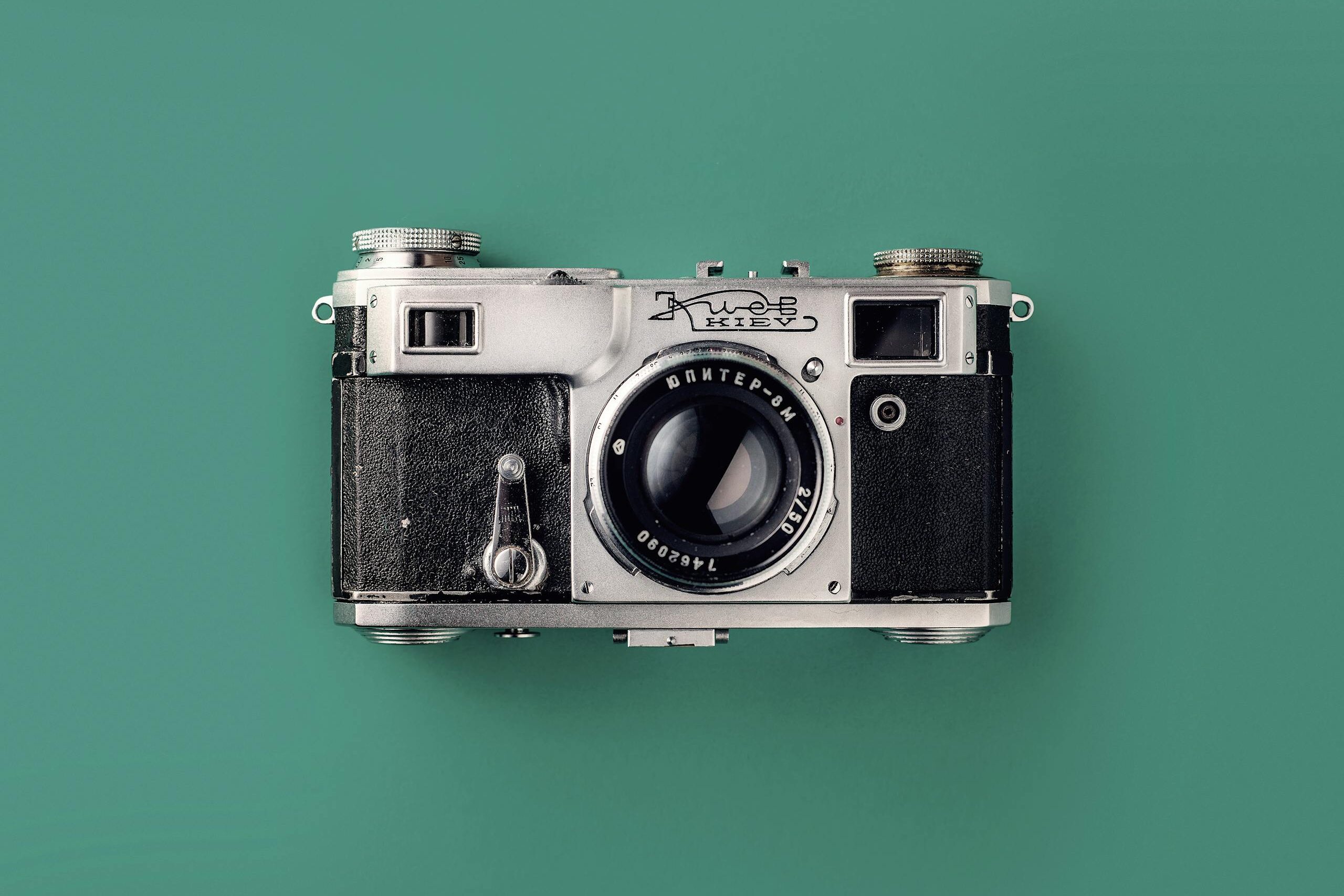 Classic vintage camera with a green background, symbolizing retro photography and nostalgia.